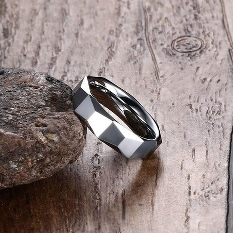 Image of Tungsten Men's Wedding Band with Geometric Design Leaning Against Rock | The Flywheel