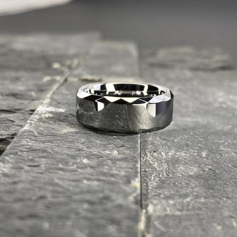 Image of Tungsten Men's Wedding Band with a Geometric Design and High Gloss Finish Close Up on Slate | The Hammer