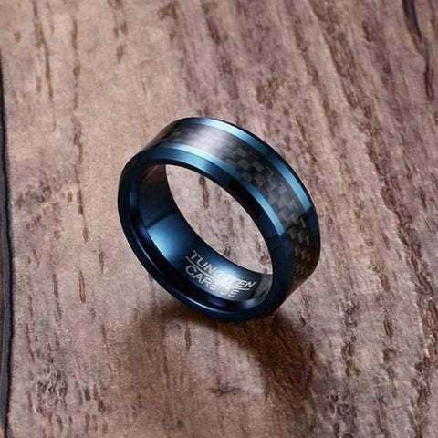 Image of Blue Tungsten Men's Wedding Band with Black Carbon Fiber Inlay and Beveled Edges on Wooden Background | The Speedway