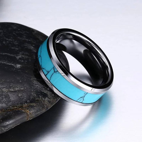 Image of Tungsten Men's Wedding Band with Turquoise Inlay and Beveled Edges Leaning Against Rock | The Trailblazer
