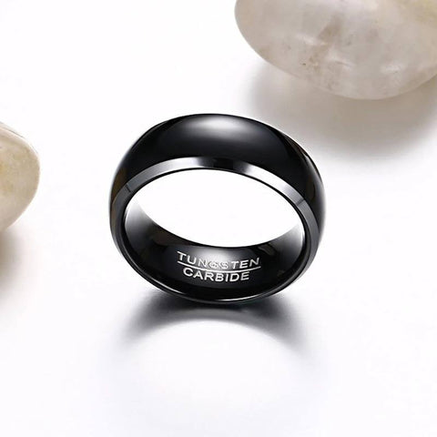 Image of Black Men's Tungsten Wedding Band with Silver Edging Next to White Rock | The Black Pearl