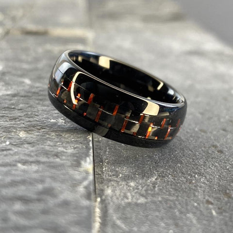 Image of Black Tungsten Men's Wedding Band with Red Carbon Fiber Inlay On Slate | The Commander 