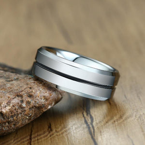Men's Wedding Band With Black Inlay Leaned Against Rock | The Diplomat