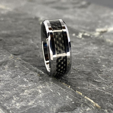 Image of Tungsten Men's Wedding Band with Black Carbon Fiber Inlay and Beveled Edges Close up On Slate | The Executive