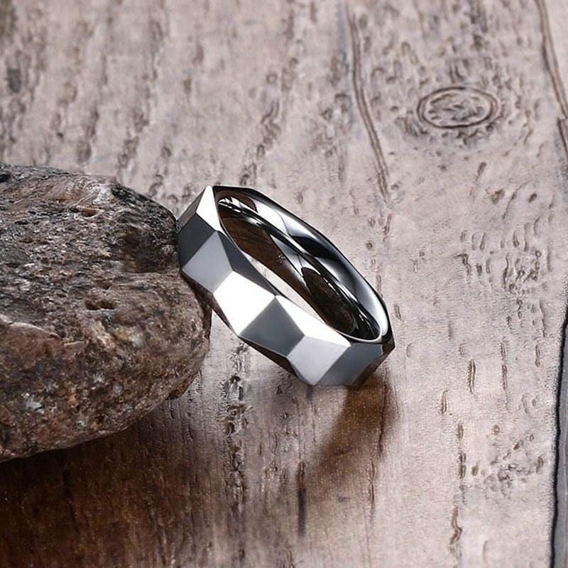 Tungsten Men's Wedding Band with Geometric Design Leaning Against Rock | The Flywheel