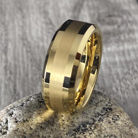 Image of Gold Men's Tungsten Wedding Band with Beveled Edging on a Rock | The Arthur