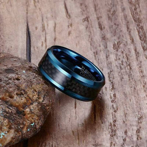 Blue Tungsten Men's Wedding Band with Black Carbon Fiber Inlay and Beveled Edges Leaning Against Rock | The Speedway